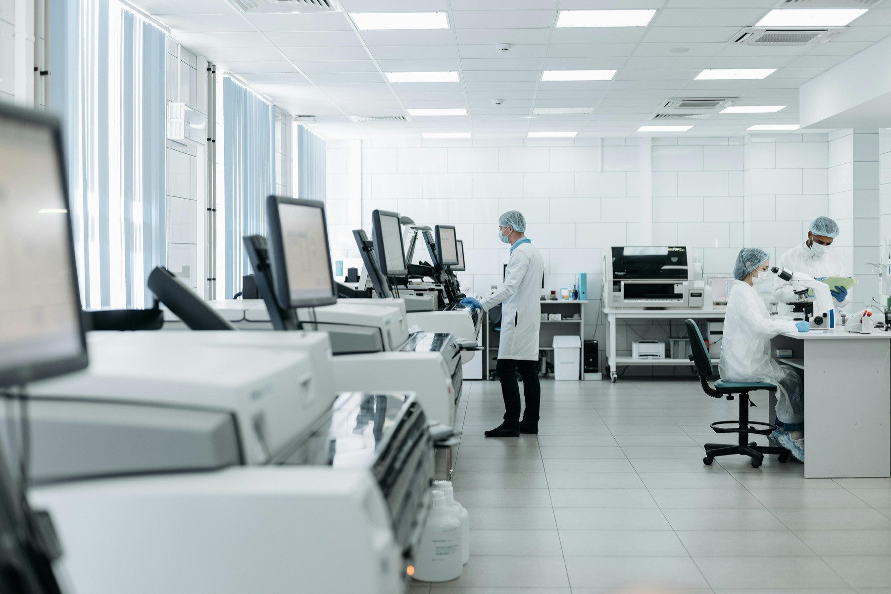 Scientists working in a biomedical testing laboratory